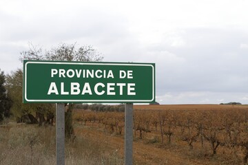 Green road sign with white letters indicating the provincial limit with the Spanish province of...