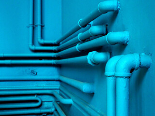 Thin Blue pipes on the wall.