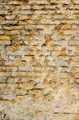 Mixed color industrial brick wall. Tiled. Vintage effect. Background of brick wall texture. Yellow brick wall background in rural building