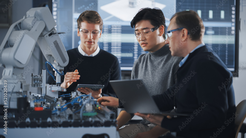 Fototapete students advising with their male teacher while working on project with robotic arm. young people us