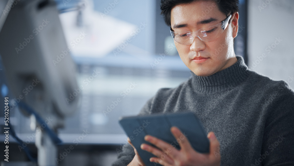 Leinwandbilder Student Using Tablet to Controll Robotic Hand. Bionic Arm Moving in Different Directions During University Class. Asian Man Developing Software For Robotics Facility. Computer Science Concept.