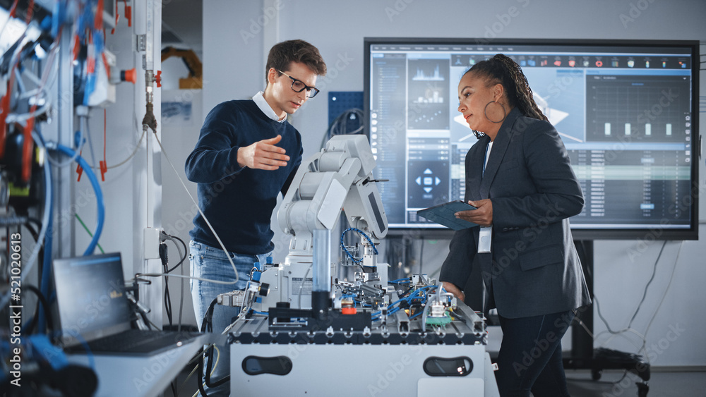Aufkleber Futuristic Design of AI Robot Hand. Black Engineer Telling About Innovative Robot Arm to Students or Start-uppers. Advanced Robotics Technology for Factory Working Concept. Slow Motion.