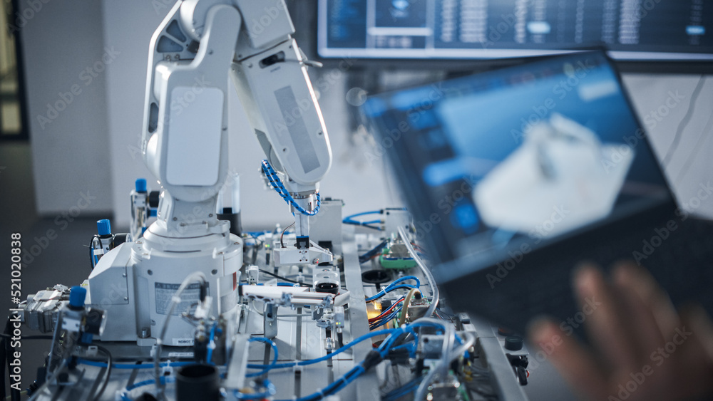 Poster black female engineer using laptop for programming robotic arm at the futuristic advanced factory. n