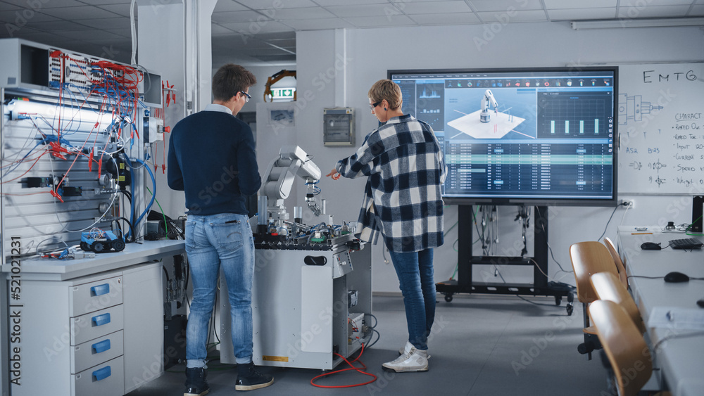 Poster Diverse Students Standing Near Table With Robot Arm, Manipulating and Programing It to Move on Digital Devices. Bright Facility, Creative People Working Together on Advanced Technology.