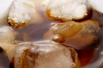 Cuba libre cocktail isolation on a white, Rum with cola and ice in a glass close-up