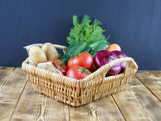 Basket with vegetables. Tomatoes, onions, labeling, potatoes, cucumbers and dill.Close-up.