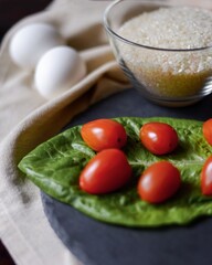 tomatoes and chicken eggs on the table next to a glass bowl of rice