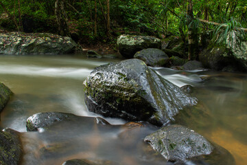 small waterfall In the midst of nature, blurry branches