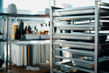 Interior professional restaurant kitchen, rack with baking sheets