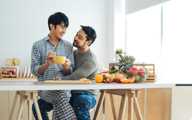Gay LGBT sweet Asian couple wearing pajamas, smiling, hugging with happiness and love after wake up...