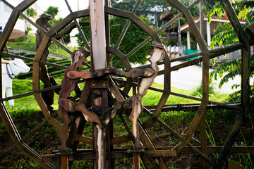 Wooden turbine baler or wood water wheels in creek canal for treatment water on pool pond at...
