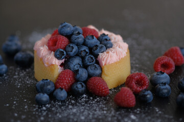 Cake with cream covered with juicy berries.