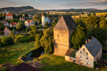 The gothic Siedlecin Ducal Tower illuminated by the setting sun in the Bobr Valley Landscape Park,...