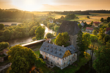 The gothic Siedlecin Ducal Tower illuminated by the setting sun in the Bobr Valley Landscape Park,...