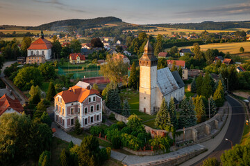 The church in historical Siedlecin town illuminated by the setting sun in the Bobr Valley Landscape...