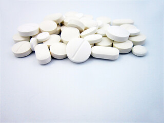     Pharmacy, stack of white flat medicine tablet pills. shallow DOF                                 