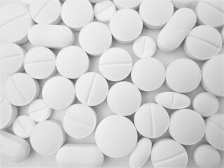       Pharmacy, stack of white flat medicine tablet pills. shallow DOF       