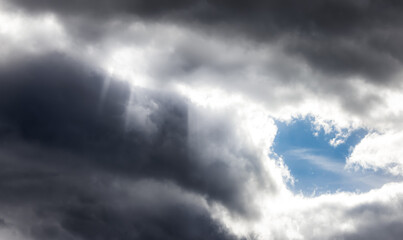 Dramati Dark Clouds in the Sky with Sunrays. Cloudscape Background