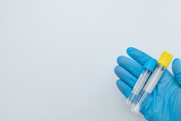 Two vacuum tubes for collection and blood samples with sodium citrate in blue gloves for...