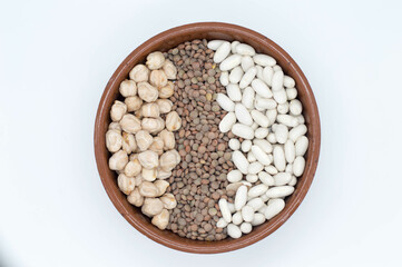 Bol con legumbres, lentejas, garbanzos sobre fondo blanco.