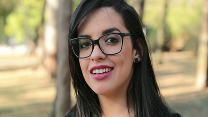 Hispanic woman wearing glasses looking to camera Smart Latina