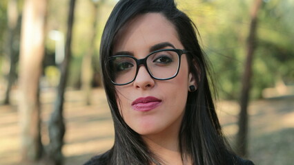 Hispanic woman wearing glasses looking to camera Smart Latina girl