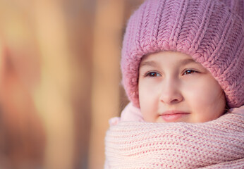 portrait of a baby girl in a pink hat and scarf