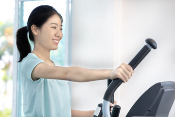 Beautiful and shapely Asian woman working out in the gym, Play exercise machine treadmill, Dumbbell, stretching, Hanging bar, Barbell, Cardio, Stretch, Woman warming up in the gym, Jump rope.
