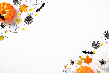 Modern Halloween background with pumpkins, bats, spiders, webs, ghosts, decorations on white table....