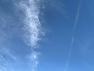 Clouds and vapor trail in blue sky