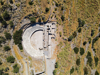 top panoramic aerial shot drone of ancient roman theater in the Tripiti village at Milos island, cyclades, greece