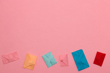 small colorful letters at the bottom pink background, copy space above, creative art fashion desgin
