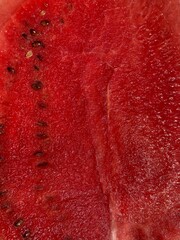 a sliced watermelon with red fruit flesh and seeds