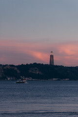Sunset view of Cristo Rei over the river