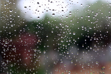 Naklejka na ściany i meble Rain drops on a window. Abstract background. Drops on a glass surface. 