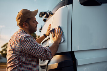 Young driver cleaning his truck before the ride.