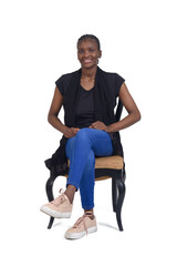 full portrait of a smiling woman sitting on chair cross-legged over white background