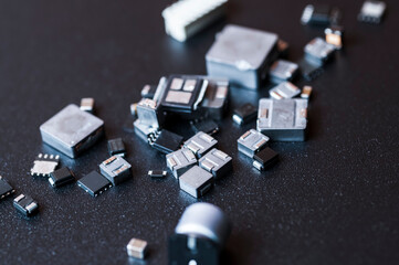 Top view of various electronic components on black background.