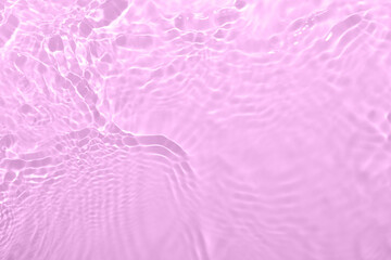 Closeup of pink transparent clear calm water surface texture with splashes and bubbles. Trendy...