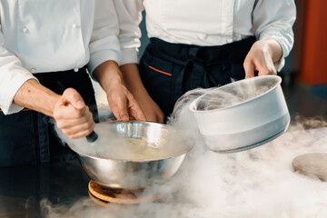 Professional kitchen, chefs use liquid nitrogen to cook molecular food in a restaurant