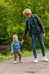 Fototapeta premium beautiful girl with a boy in the park on the background of the lake in the park