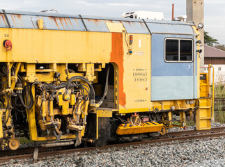 The ballast tamping machine is working to maintain the sleeper and ballast stone.