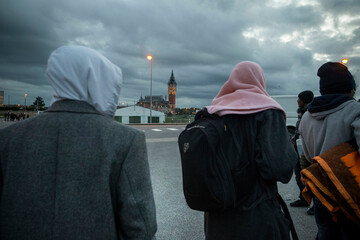 Refugee Crisis in France. October 25, 2014. Calais, France. A group of refugees walk in the center of the city. Calais is a major step for thousands of migrants who try to pass in secret in England. - obrazy, fototapety, plakaty