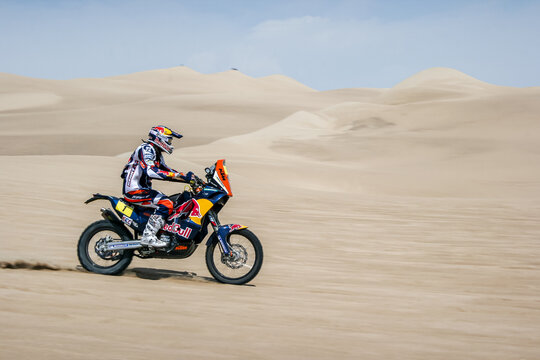 Dakar rally participant at the desert dunes in Peru. Motorbike, bike, moto. red bull 