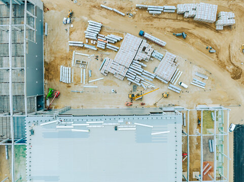 Construction Site. Aerial Photo of Busy Industrial Plant under Construction. Factory Building. Construction Site with Cranes and Heavy Equipment.