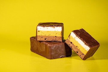 Candy made of multi-colored, puff souffle, covered with chocolate. Multi-colored, puff, sweet souffle covered with chocolate.