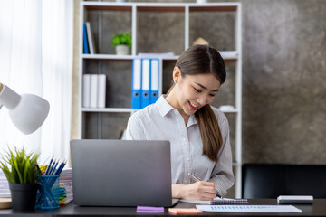 Portraits of beautiful Asian businessmen, business women leaders, women working in a startup company office, managing a growing and profitable company. Business management concepts from female leaders