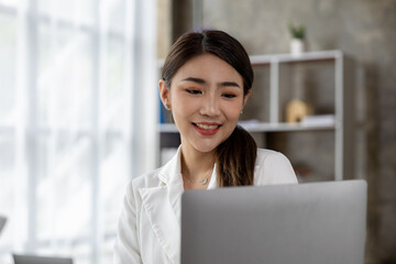 Portraits of beautiful Asian businessmen, business women leaders, women working in a startup company office, managing a growing and profitable company. Business management concepts from female leaders