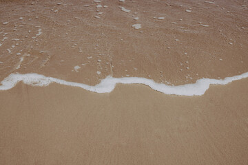 Fototapeta na wymiar Seascape, waves, sun, sand, foam.