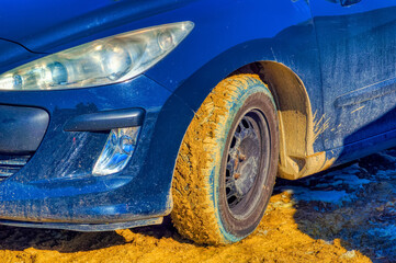 Muddy car tire during winter day in Knezevo, Bosnia and Herzegovina. 